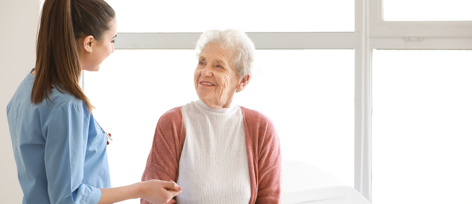 rehab nurse working with older woman